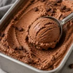 A delicious bowl of rich chocolate ice cream topped with chocolate shavings.