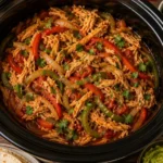 Delicious crockpot chicken fajitas ready to serve with colorful bell peppers.