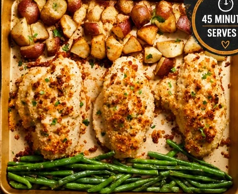 Parmesan crusted chicken on a sheet pan with roasted vegetables