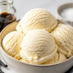 Delicious bowl of creamy vanilla ice cream topped with fresh strawberries